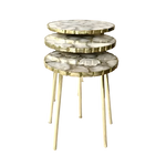 Three white crystal agate round nesting tables stacked in graduated sizes, each with gold-rimmed edges and gold hairpin legs