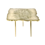 White agate quartz organic edge accent side table, pale cream-gold agate slab with jagged natural gold lava rim on three tall slim brass legs