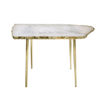 Rose quartz organic edge accent table with pale lavender-white slab top on four slim brass legs, white background