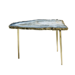 Grey agate side table with blue-tinted organic slab top on slim gold brass legs, white background