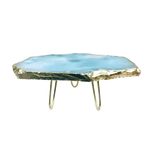 Blue agate cake stand with brass legs - round blue-navy agate slab top with concentric ice-blue rings, three slender brass legs, white bg
