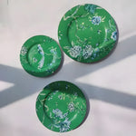 Jade phoenix floral dinnerware three plates overhead on white, emerald green with blue phoenix and floral motifs