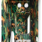 Custom wallpaper dark jungle print with golden cheetahs and tropical leaves in bathroom with brass fixtures and globe lights