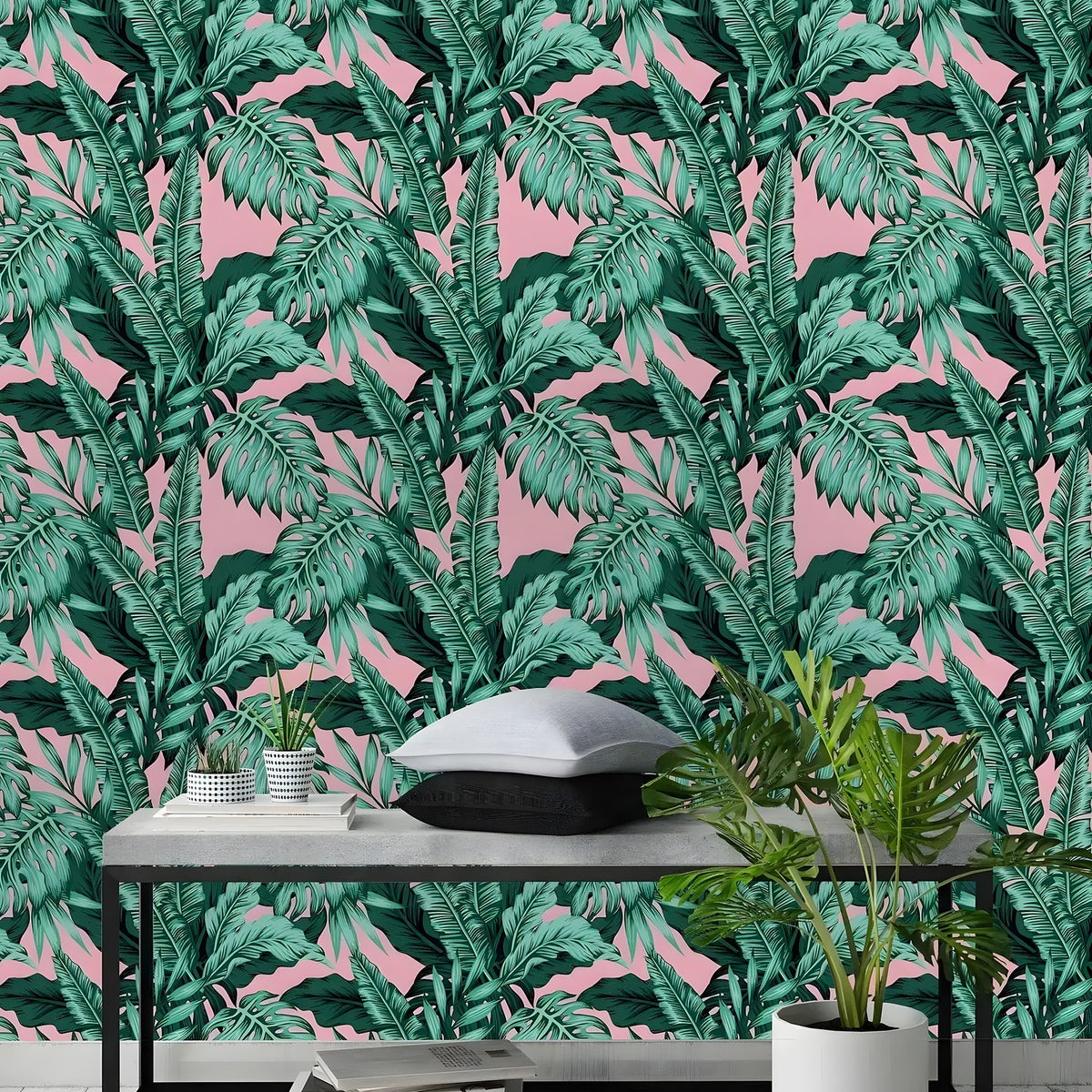 Tropical monstera wallpaper installed in room with concrete bench and plant, dense green leaf pattern on pink background