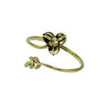 Open-ended gold brass Rumduol flower bangle on white background, 3-petal flower at one end and small leaf sprig at the other