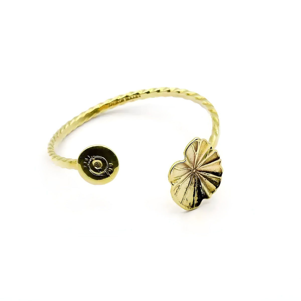 Gold brass lotus leaf bangle with twisted open band, bullet casing end and sculpted leaf charm, white background