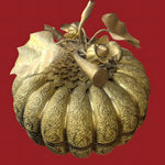 Cambodian engraved brass pumpkin betel box, gold, intricate floral scrollwork, decorative stem and leaves, against red