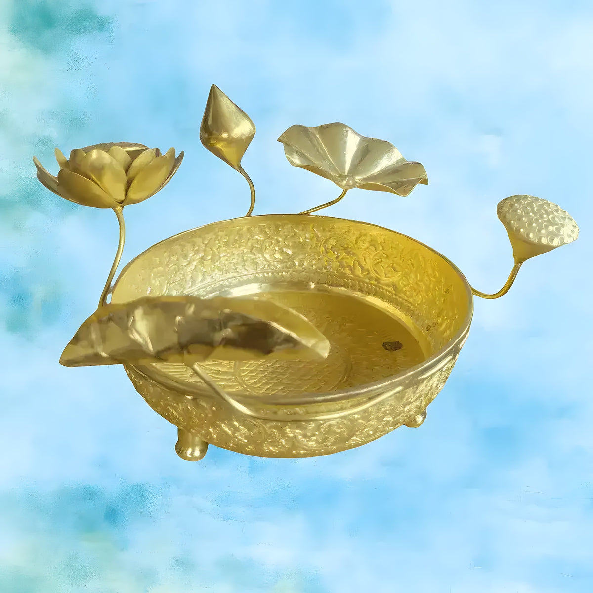 Gold brass 3D lotus legged bowl with engraved sides, lotus flower stems and carp fish inside on blue background