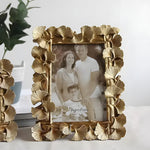 Brass Ginkgo Leaf Photo Frame in antique gold with embossed leaf clusters surrounding a 4-inch family portrait