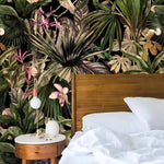 Enchanting jungle symphony wallpaper in a bedroom, dense dark tropical canopy with green palms, pink orchids and exotic blooms