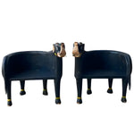 Pair of hand crafted wooden elephant Maharaja chairs in dark navy with gold anklets and carved elephant head backs, front view.