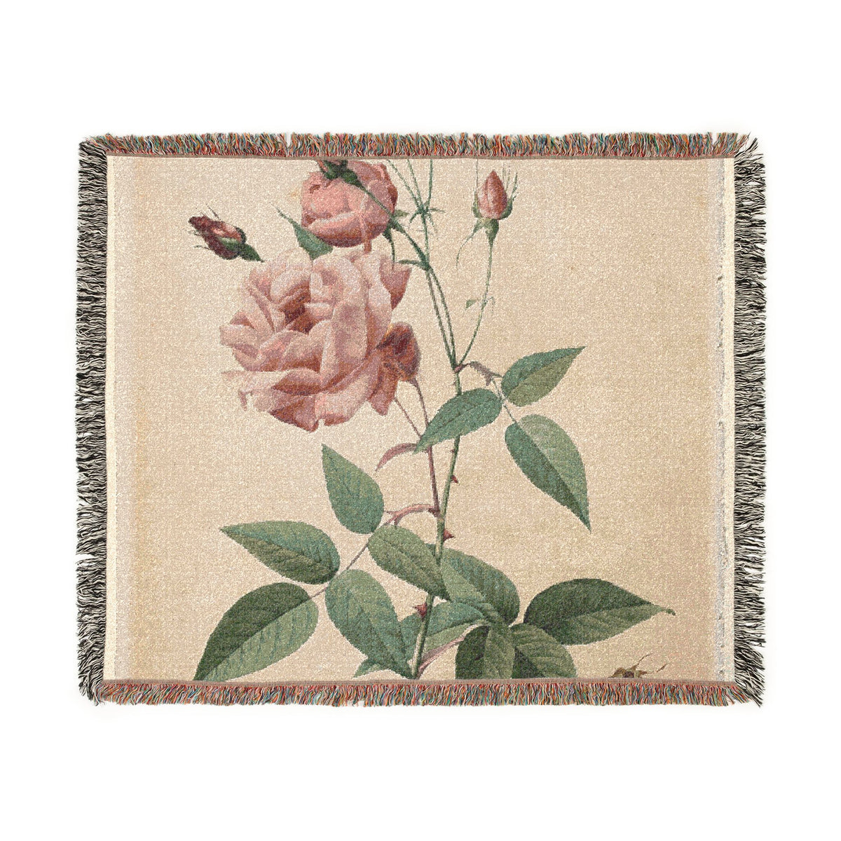 A woven throw blanket featuring a vintage-style botanical print of pink roses and green leaves on a beige background, finished with fringed edges.