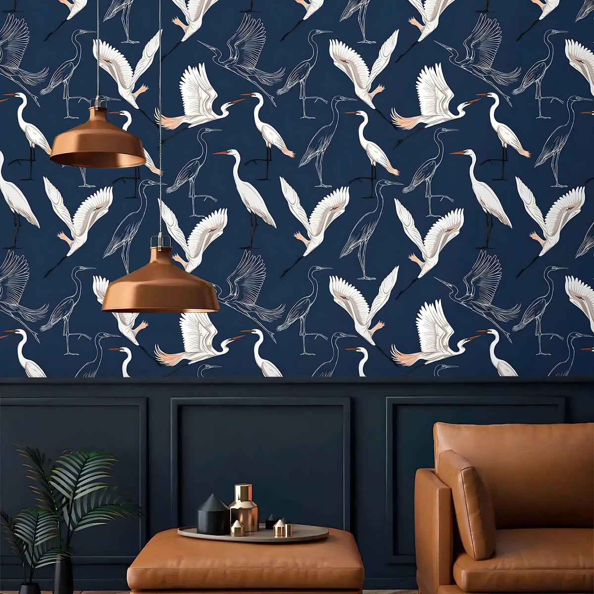 Navy wallpaper with white flying cranes above panelling with copper pendant lamps and tan leather seat