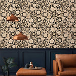 Black and gold damask floral scroll wallpaper above navy panelling with copper lamps and tan leather