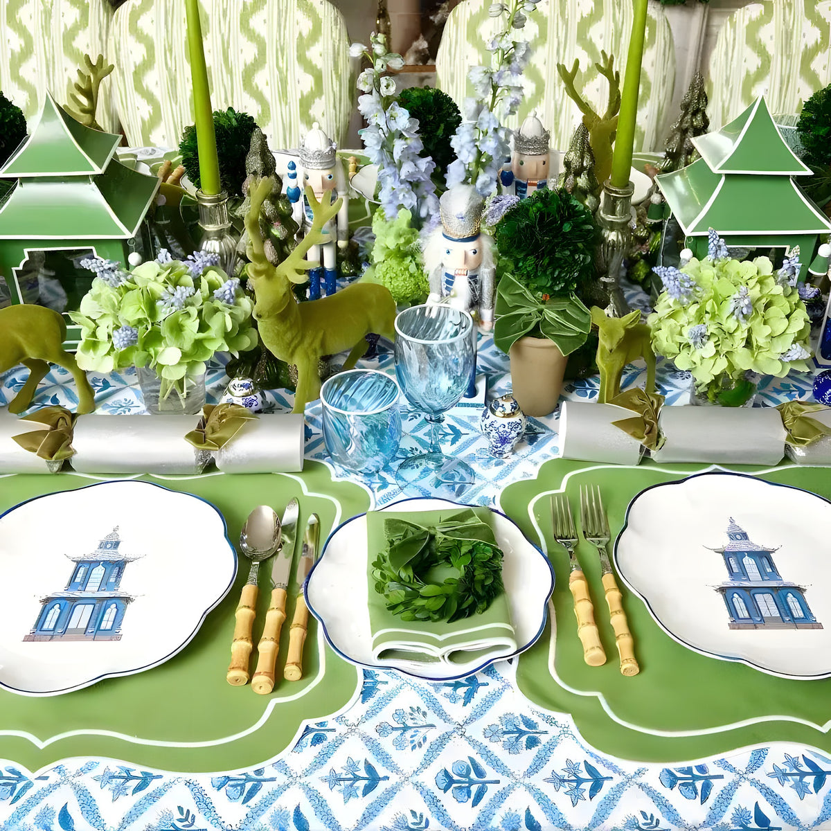 Lush lime delight placemats in bright green with white scalloped edge, styled at festive table with blue printed runner, nutcracker decor and green candles