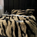 Faux Fox Fur Plush Weighted Blanket on bed, golden-tan with dark brown tiger stripes, long plush pile, black upholstered headboard