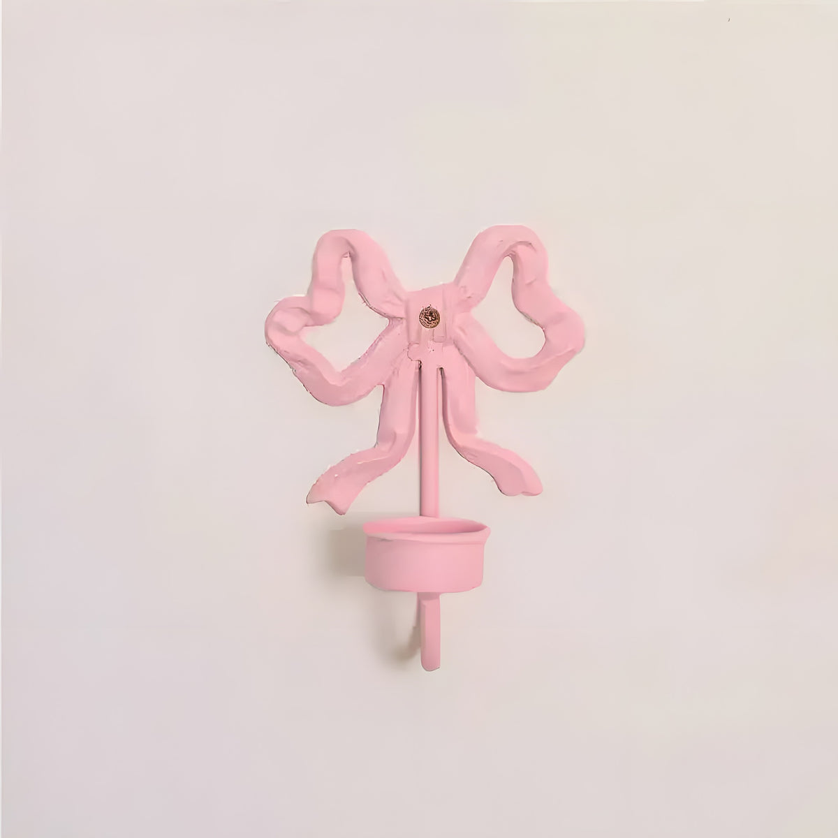 Pink Bow Wall Candlestick Holder cast metal bow-shaped wall-mount with small candle cup front view