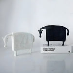 Pair of winter horse sculptures in white and black woven texture finish, standing on marble surface, front view