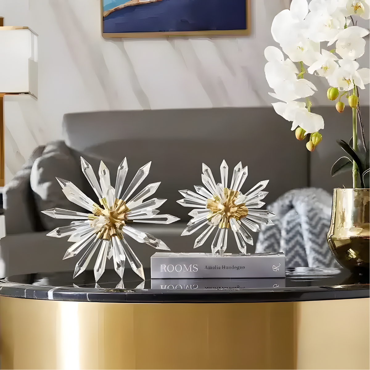 Creative Crystal Sea Urchin Sculpture clear crystal spike rays gold base two pieces on marble coffee table with orchid flower in-room