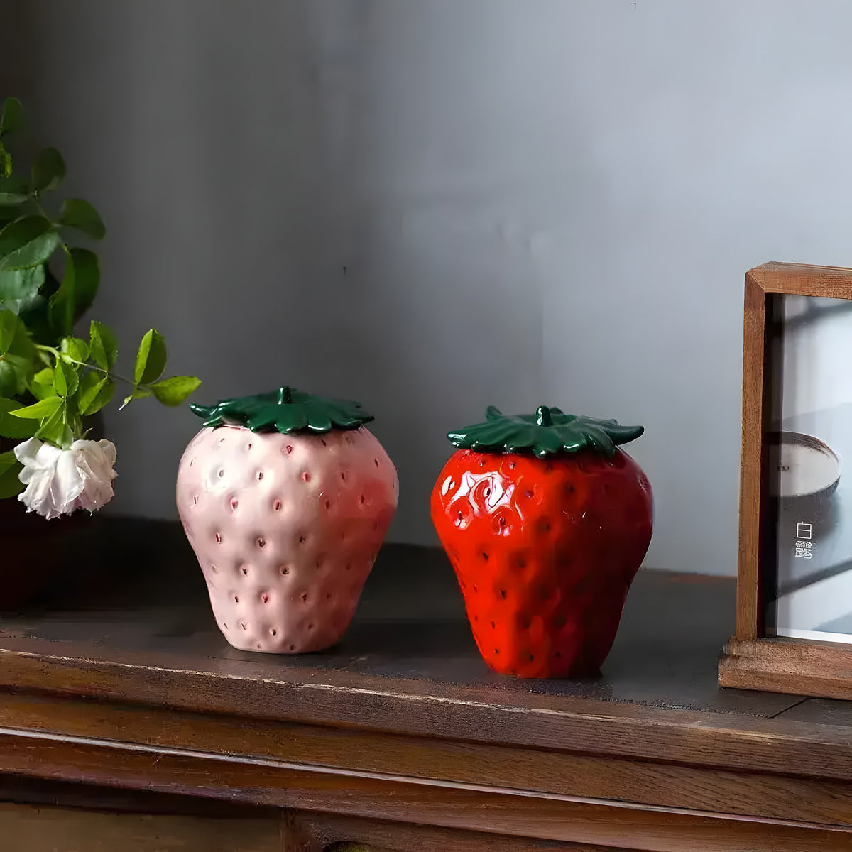 Strawberry Storage Jar is a charming and functional kitchen container designed to store food while adding a touch of whimsy to your space. Typically made of ceramic, glass, or plastic, these jars are shaped like strawberries or feature strawberry motifs. The jar often has a tight-sealing lid to preserve the freshness of stored items, such as fruits, jams, or even dry goods like sugar, flour, or snacks.

