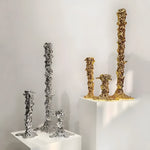 melting candle holder is a decorative and functional item designed to hold candles while giving the illusion that the candle is melting in a unique and artistic way. Typically made from materials such as metal, ceramic, or glass, the holder is crafted to mimic the natural flow of wax as it drips down the sides of the candle. These holders often feature intricate shapes or designs that enhance the visual appeal as the candle burns.