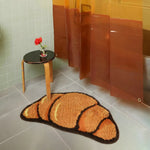 A Croissant Shaped Bathmat is a unique and playful home accessory designed to bring a touch of fun and creativity to your bathroom. Shaped like a croissant, the mat typically features a soft, plush texture, often made from high-quality materials like cotton, microfiber, or a blend of fabrics for maximum comfort and absorbency. The shape mimics the iconic crescent curve of a croissant, with some designs even incorporating realistic details like texture patterns to enhance its appeal.