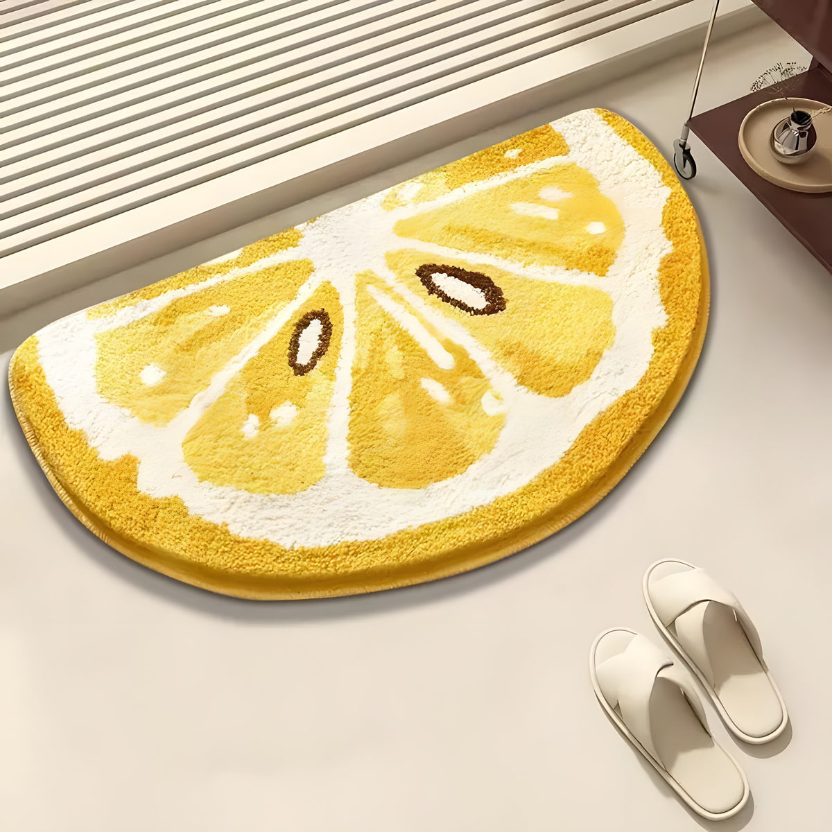 Lemon slice design rug on a light surface with white slippers nearby