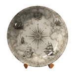 Decorative plate with world map and compass design on a stand