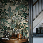 Decorative wallpaper with nature-themed design in a room with a wooden table and decorative items.