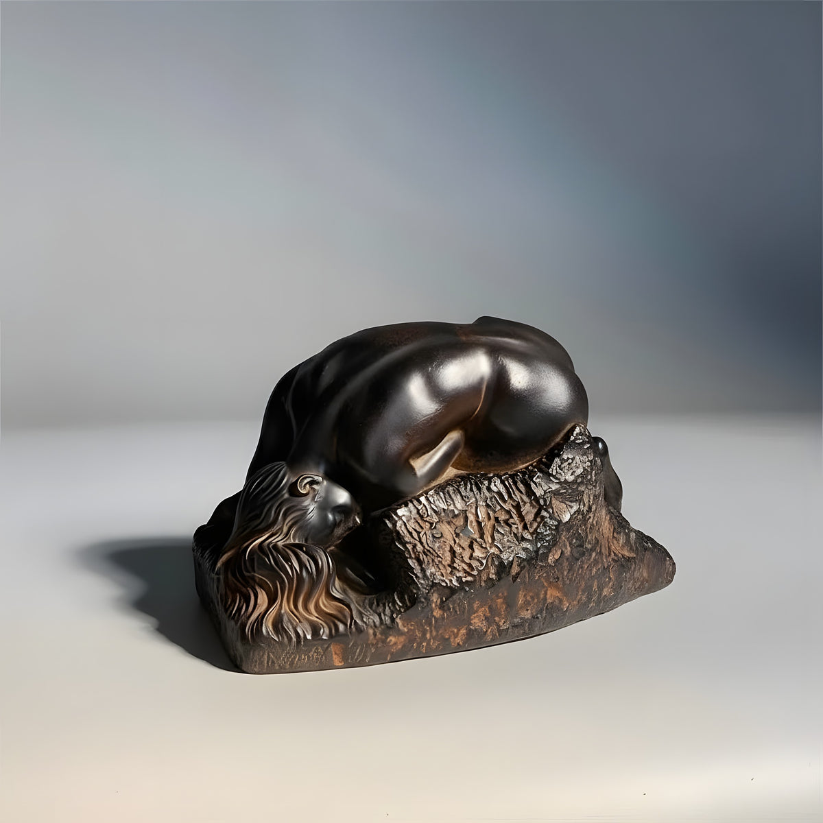 Bronze sculpture of a lion on a stone base against a gradient background