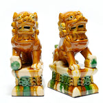 Pair of ceramic lion statues on a white background