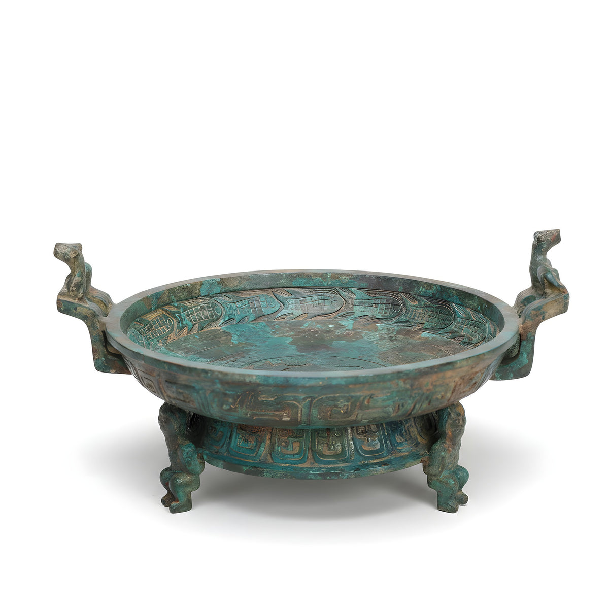 Bronze dish with intricate designs on a white background