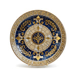 Decorative mosaic plate with blue and gold patterns on a dark background