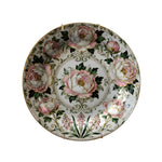 Decorative plate with floral design on a dark background