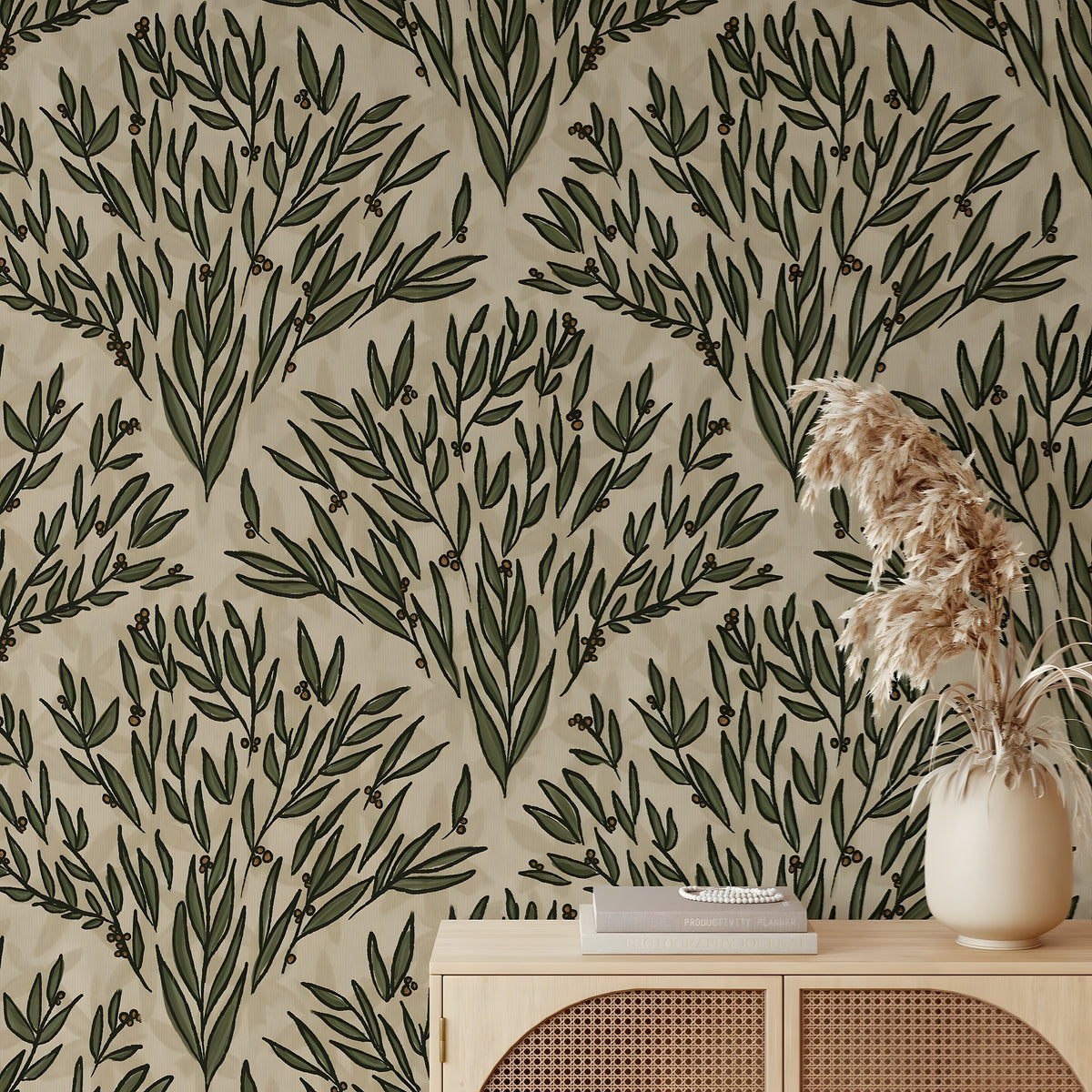 Wallpaper with green leaf pattern on beige background, with a vase and books on a wooden surface.