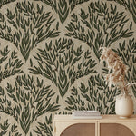Wallpaper with green leaf pattern on beige background, with a vase and books on a wooden surface.