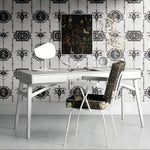 Modern office desk with chair against decorative wallpaper