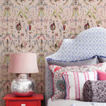 Decorative room interior with a chair, lamp, and colorful pillows against a patterned wall.