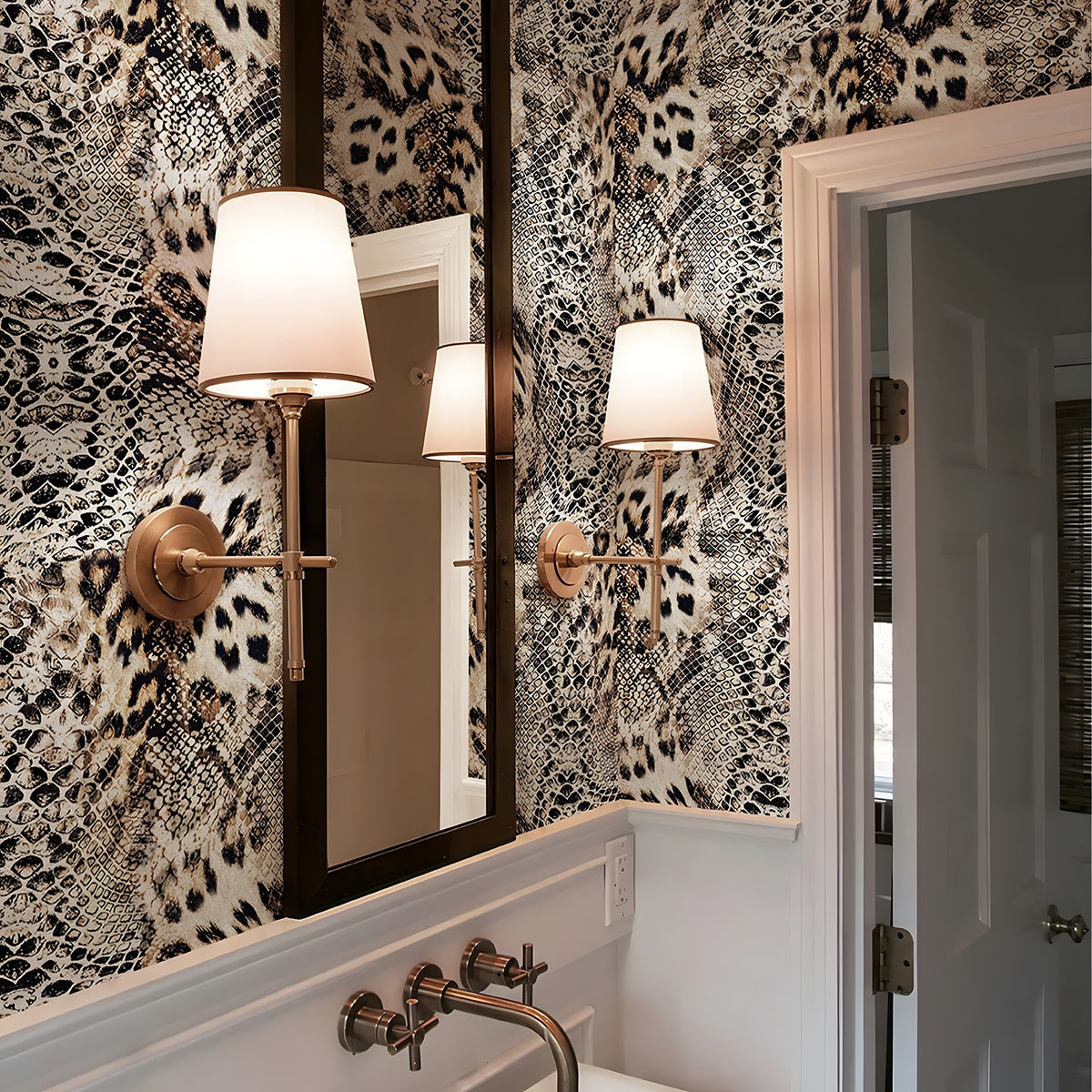Bathroom with patterned wallpaper, mirror, and wall lights.