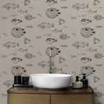 Bathroom with a wooden vanity, white sink, and fish-patterned wallpaper.