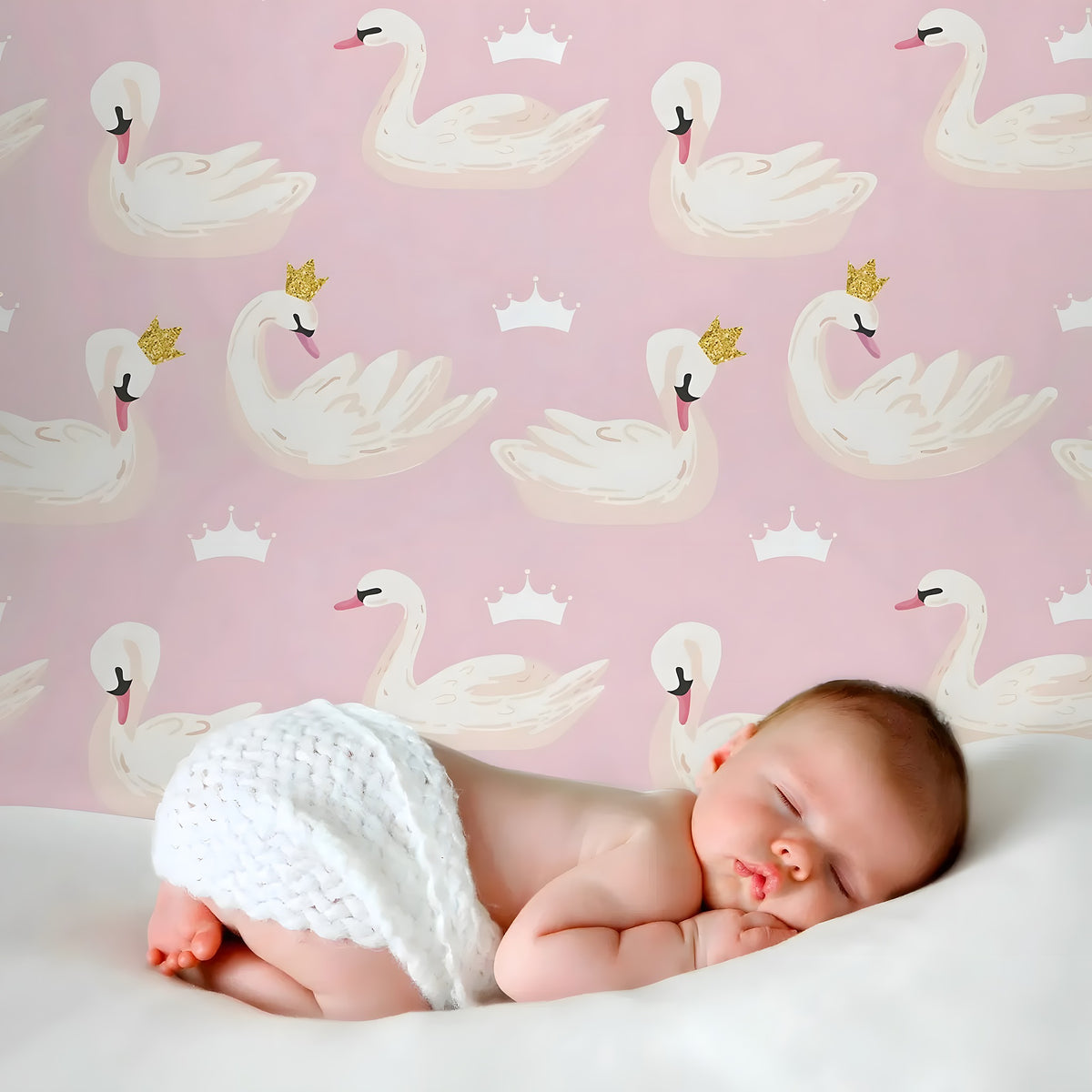 Newborn baby sleeping on a pink background with swan illustrations