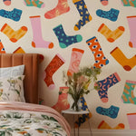 Colorful sock pattern on a wall with a bed and vase in the foreground