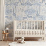 Nursery room with crib, teddy bear, and animal-themed wallpaper