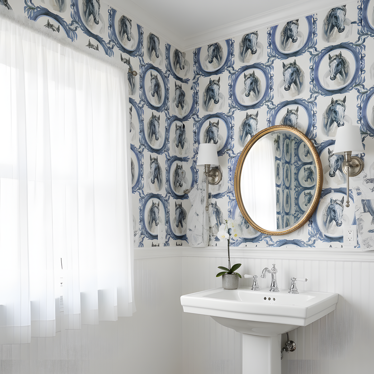 Bathroom with white pedestal sink, round mirror, and patterned wallpaper.