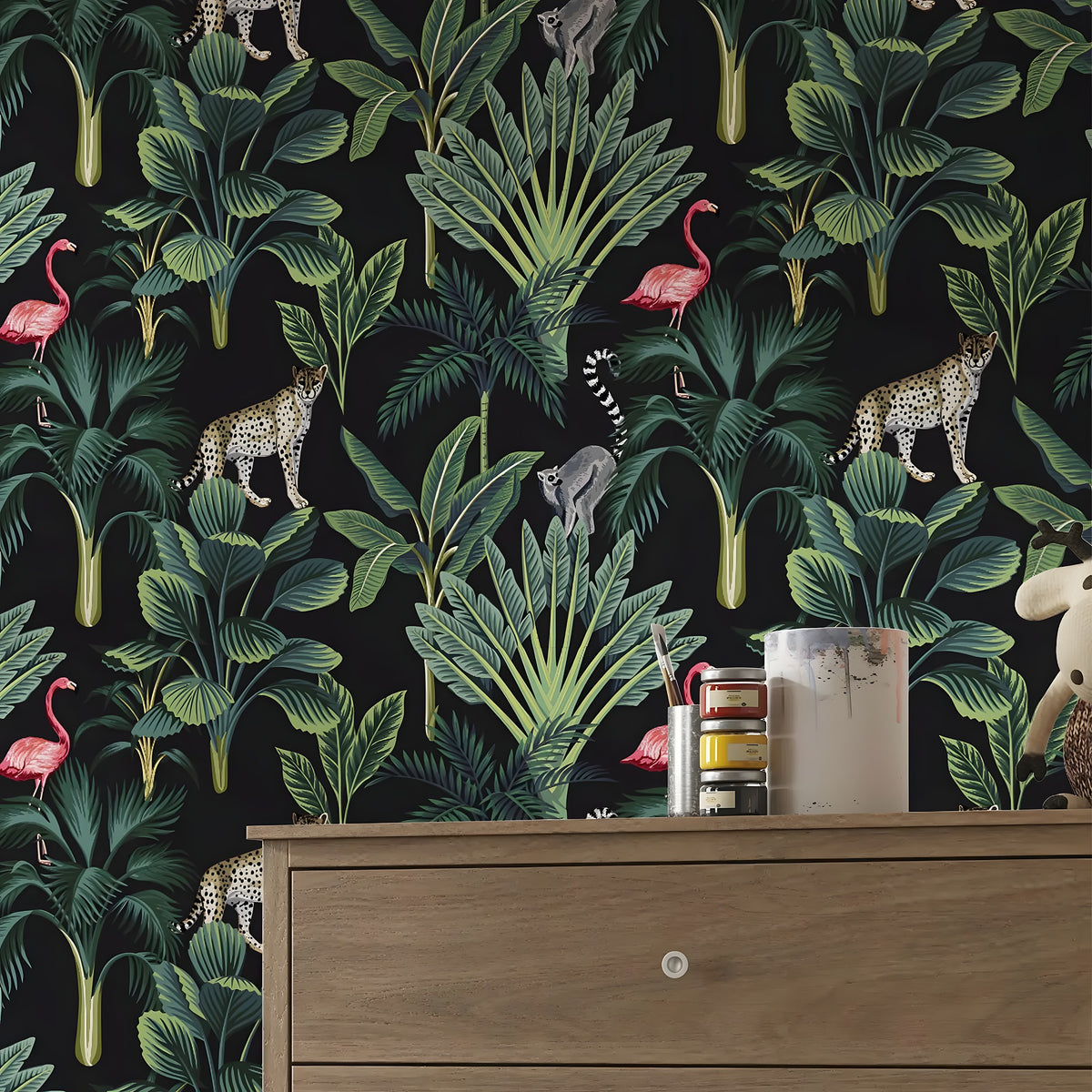 Jungle-themed wallpaper with animals and plants on a black background, displayed in a room with a wooden dresser.