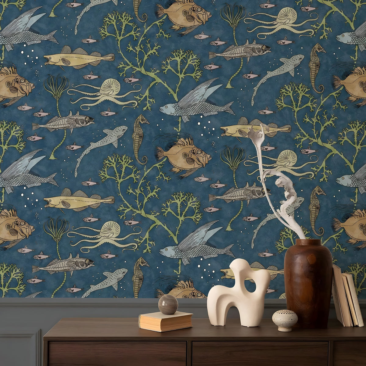 Wallpaper with marine life design in a room with decor items on a table.