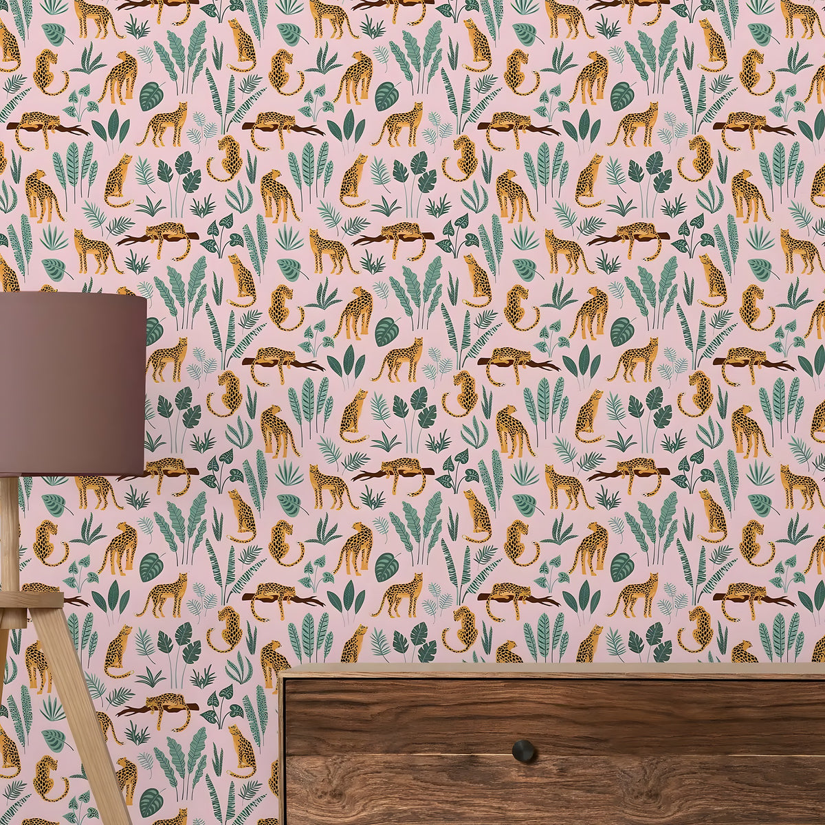 Wallpaper with leopards and foliage pattern on a pink background