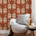Gray armchair with a patterned wall featuring tiger designs in a room.