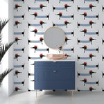 Bathroom with blue vanity and mirror against a wall with dachshund pattern