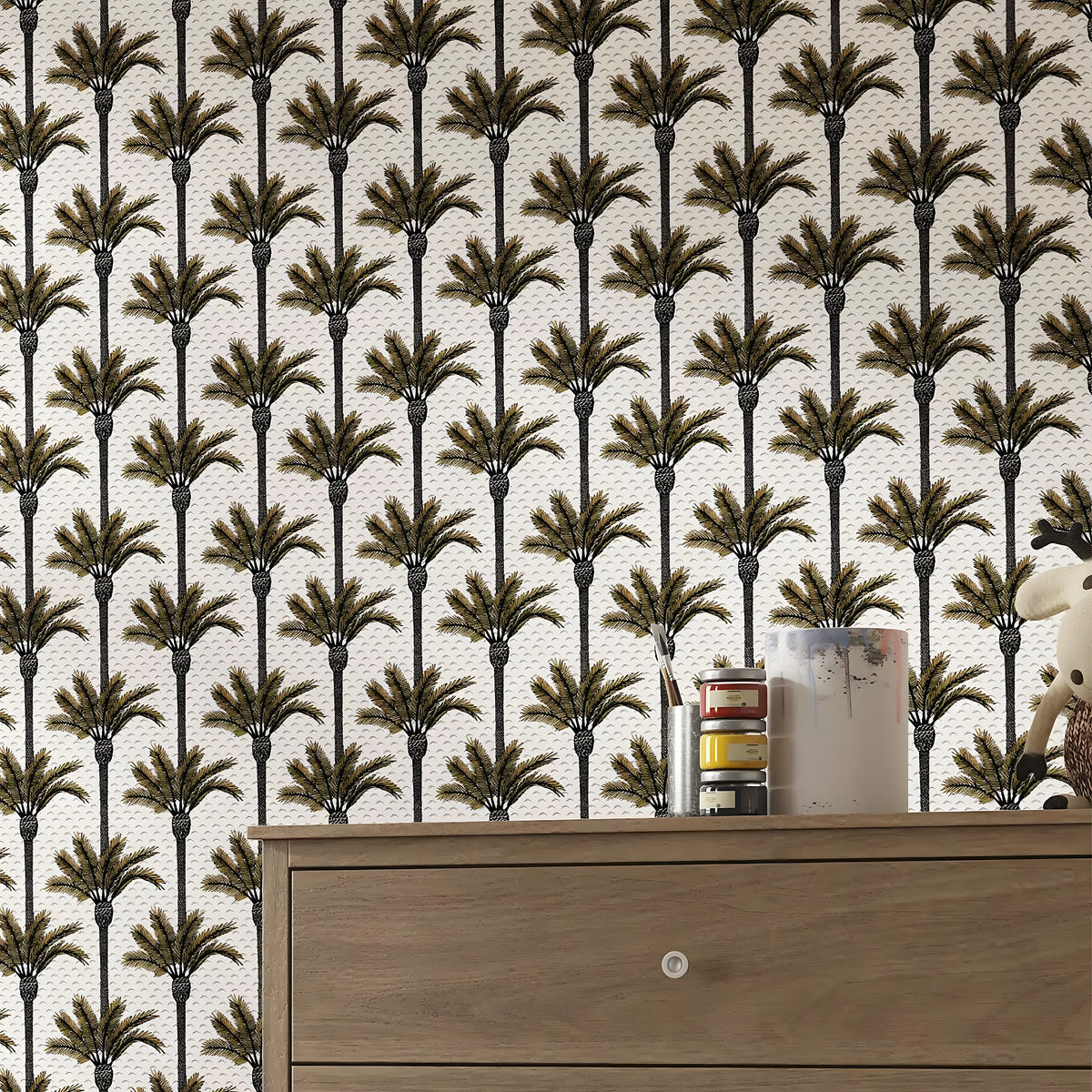 Wallpaper with palm tree pattern and a wooden dresser in the foreground.